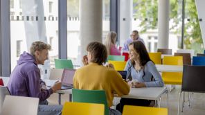 Drei Studierende sitzen am Tisch im LEO US