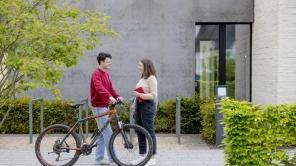 Fahrradfahrer und Studentin unterhalten sich