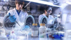 Researchers at a glovebox