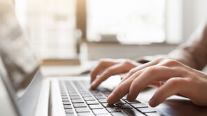 Typing on laptop closeup