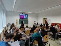 Prof. Lersch in einem Klassenzimmer vor Schülerinnen und Schülern