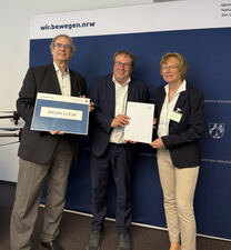 Prof. Strina, Minister Krischer und Uni-Rektorin Reese bei der Bescheid-Übergabe