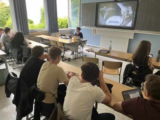 Gymnasiale Schulklasse hört einem Vortrag zu