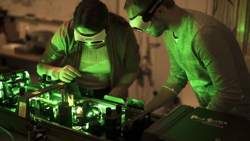 two people in a laser lab