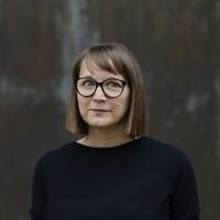 ein Foto von Daniela Wentz. Sie trägt eine schwarze Brille und hat brünette, kinnlange, glatte Haare