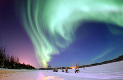 050118-F-3488S-003 EIELSON AIR FORCE BASE, Alaska -- The Aurora Borealis, or Northern Lights, shines above Bear Lake here Jan. 18. The lights are the result of solar particles colliding with gases in Earth's atmosphere. Early Eskimos and Indians believed different legends about the Northern Lights, such as they were the souls of animals dancing in the sky or the souls of fallen enemies trying to rise again. (U.S. Air Force photo by Senior Airman Joshua Strang)